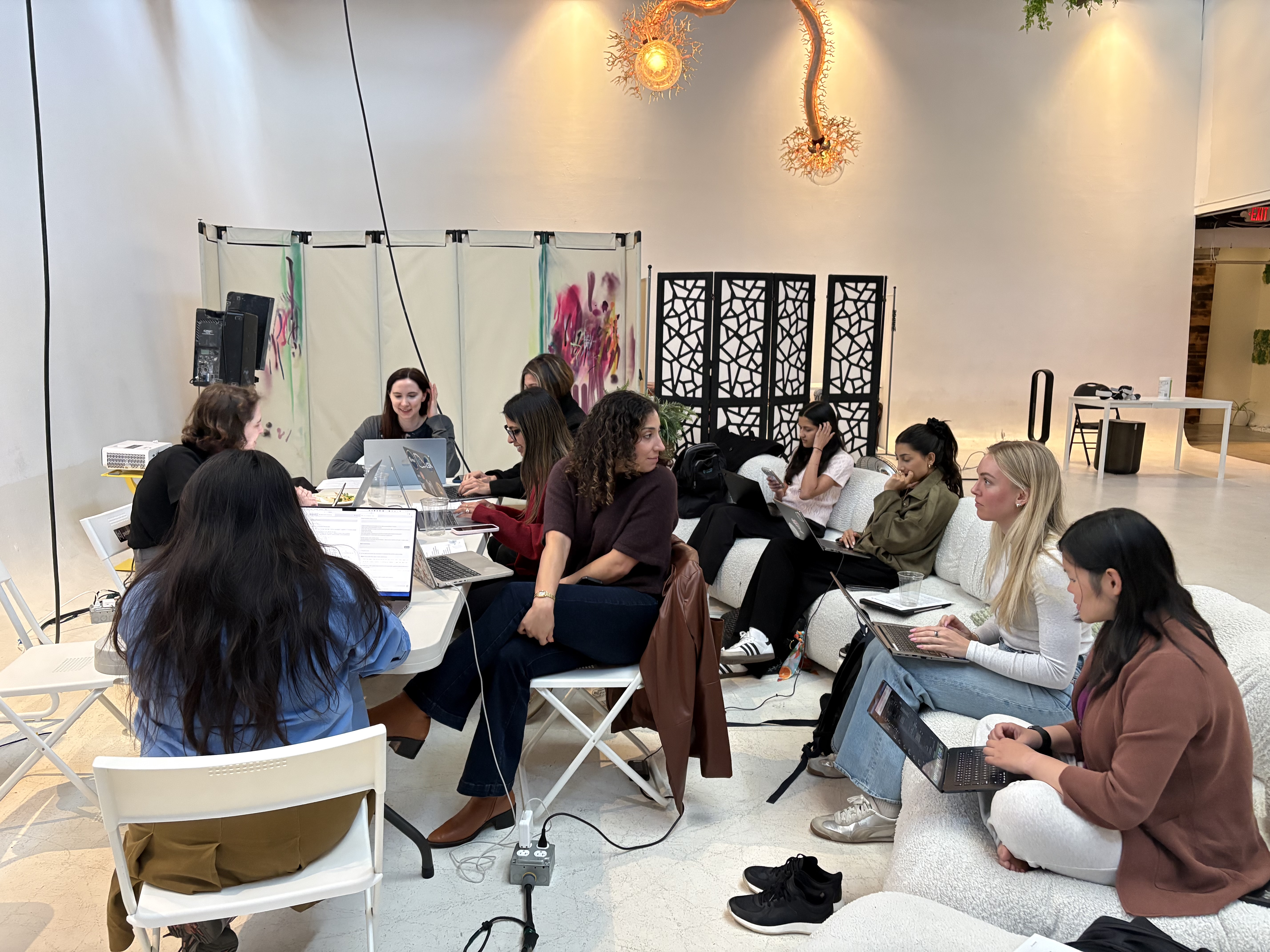 A vibe coding workshop cohort working together in the room